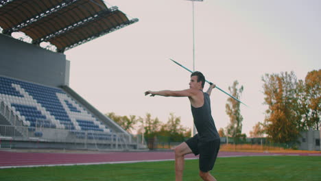 Slow-motion:-a-Male-athlete-at-the-stadium-concentrates-runs-up-and-throws-a-javelin.-Preparation-for-the-Olympic-games-all-around